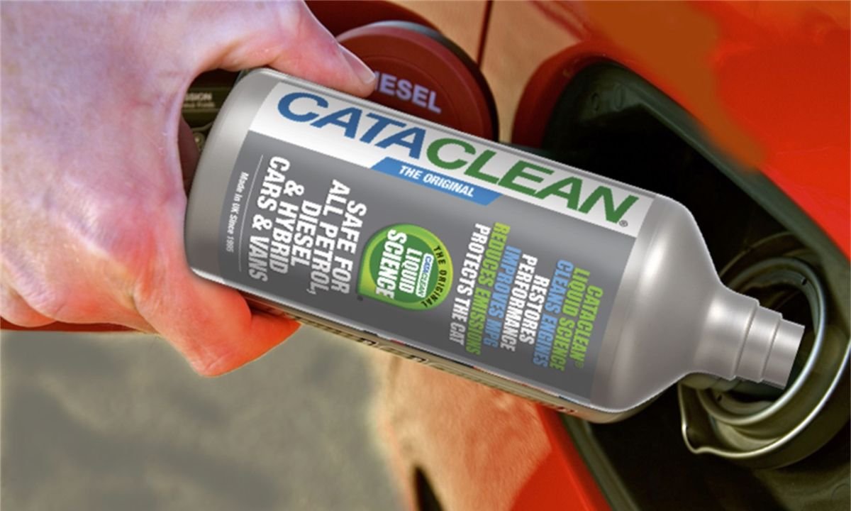 Man pouring fuel injector cleaner into car