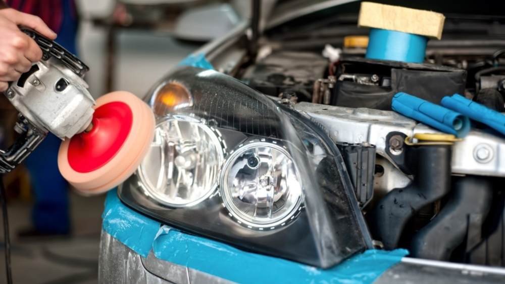 Best headlight restoration kit - man using power tool